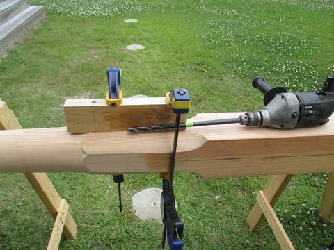 I made a drill guide jig on the drill press to ensure I drilled a straight hole. Then, I used the long bit with the drill to drill half way through the sprit. T