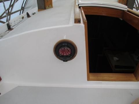 The compass installed. We moved it towards the center line of the boat to free up the back of the cabin side for comfortable lounging.