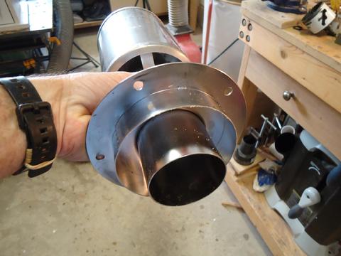 the reflecks deck flange with the smoke head attached. The flue fits inside the inner ring and the out ring is part of the heat shield.