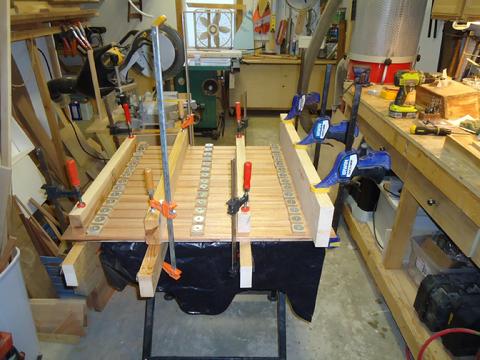 I attached the mahogany staving with epoxy and used my home built screw clamps per the same procedure I used on the rest of the staving.