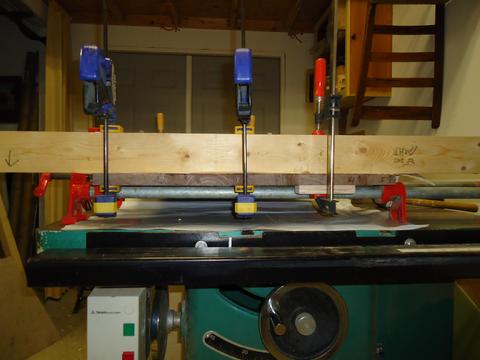 Clamped to keep it flat. I alternated the grain to reduce the chance the planks will warp.