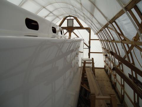 Those are not ripples or waves in the paint but the reflection of the shed cover in the paint.