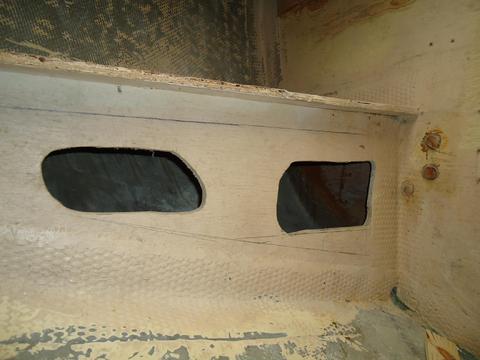 The original small openings below the shelf in the portside cockpit locker.