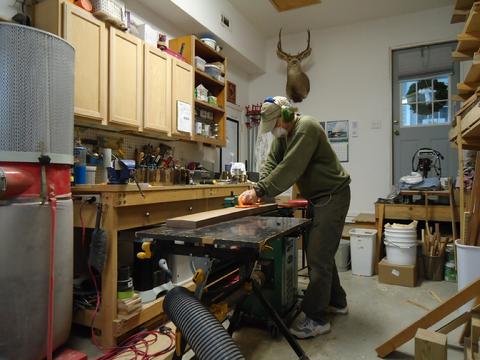 Running the walnut over the jointer to get a flat side and edge.