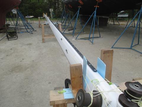 The splice is completed and the spinnaker pole track is installed. The track is long to allow the pole to be stowed vertically to the top and then to the base o