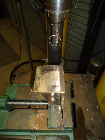 Drilling pilot holes in the stanchion bases at the Camp Lejeune Hobby Shop.