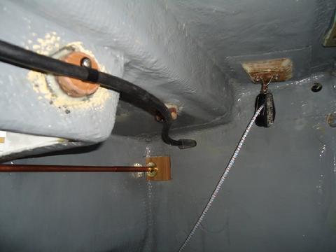 Looking aft. The copper pipe is the manual shut off from the saloon to the gas valve in the propane locker. The diagonal line is one of the control lines for th