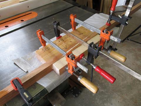 I clamped the planks together using blocks of wood to spread the load. I covered the blocks with packing tape so they would not get glued to the planks. I clean