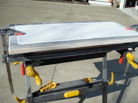 I ground a 12:1 bevel on three sides as part of the preparation to create side "lips" for the hatch.