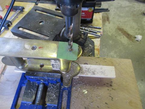 I cut a wood support block to fit between the flanges so the drill would not force the flange down during drilling.