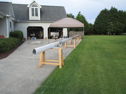 In this photo you can just make out the aluminum belaying pin rack about 7' up from the heel of the mast.