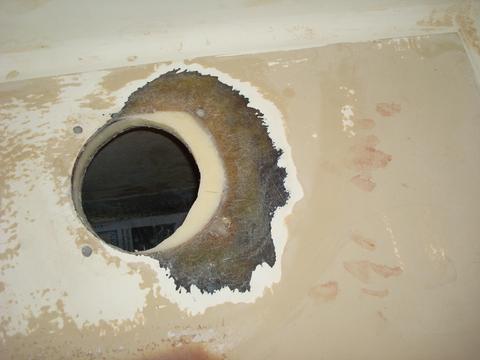 Partially complete rudder post hole. The epoxy core will be covered by a biaxial 3 layer patch.