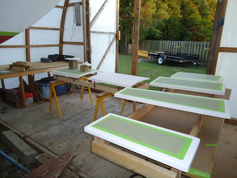 I built racks for the sea locker hatches to sit on when they are painted. The windlass platfor and tiller post flange are sitting on the sea-hood.