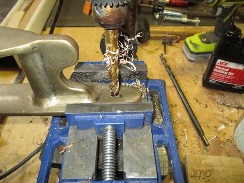 Drilling mounting holes for the bronze bow roller assembly.