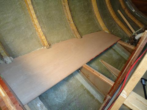 The bottom of the locker under the quarter sea-berth. You can see the small support glassed in to the hull to support the bilge pump.