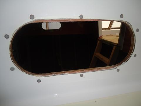 The filled holes from the outside. Note the too large cutout in the fiberglass made by Cape Dory when the boat was built. That gap will have to be filled with G