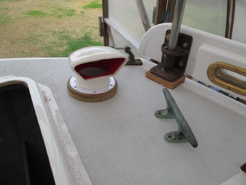 I made a trim ring from some teak cut-off. It will provide a better raised barrier to keep water out and looks better than when the vent flange was screwed dire