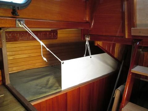 The quarter berth had unique challenges. There is not a lot of room. Also, I through bolted the hooks through the trim and then though the lower ede og the cabi