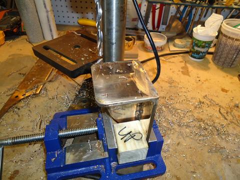 Drilling hole in the bulwark brackets in my home shop.