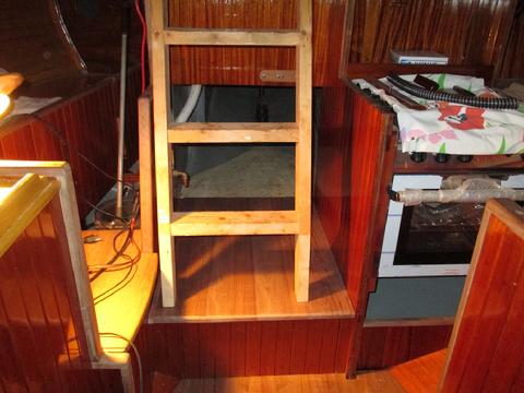 The four planks that make up the landing for the companionway ladder. I used small outboard trim strips to scribe the slighly out of square section so the plank