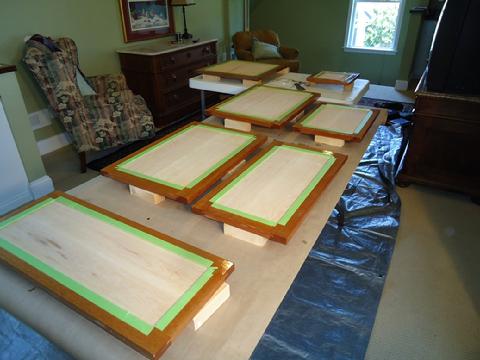 The rails and stiles are protected with tape and we are ready to start applying varnish to the panels.