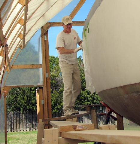 John applying release fabric over the top layer of epoxy tape.