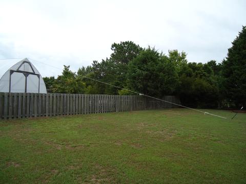 My neighbor was kind enough to let us run a guy line to a stake in her yard.