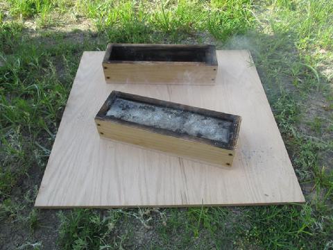 One ingot poured and the other mold ready to receive molten lead.