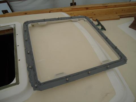 Applying the butyl to the underside of the hatch frame.