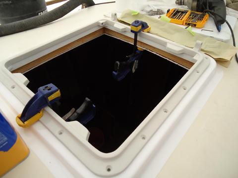 Clamping the hatch in place to use as a template for driling the holes.