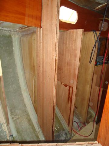 From the double berth looking aft towards head sink basin. Screw block clamps were just removed.